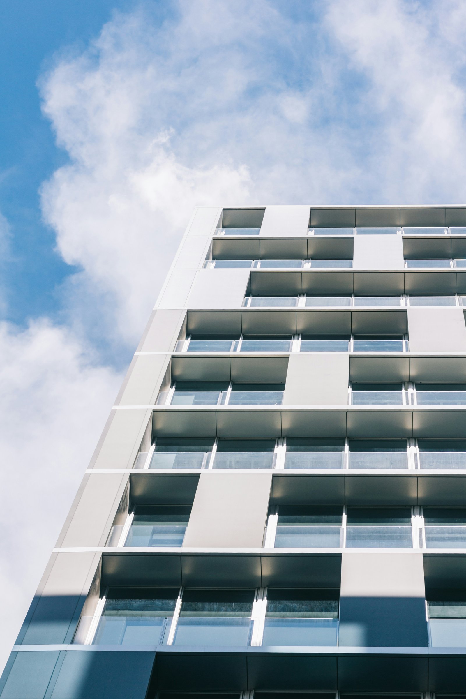 white high-rise building under white and blue skies